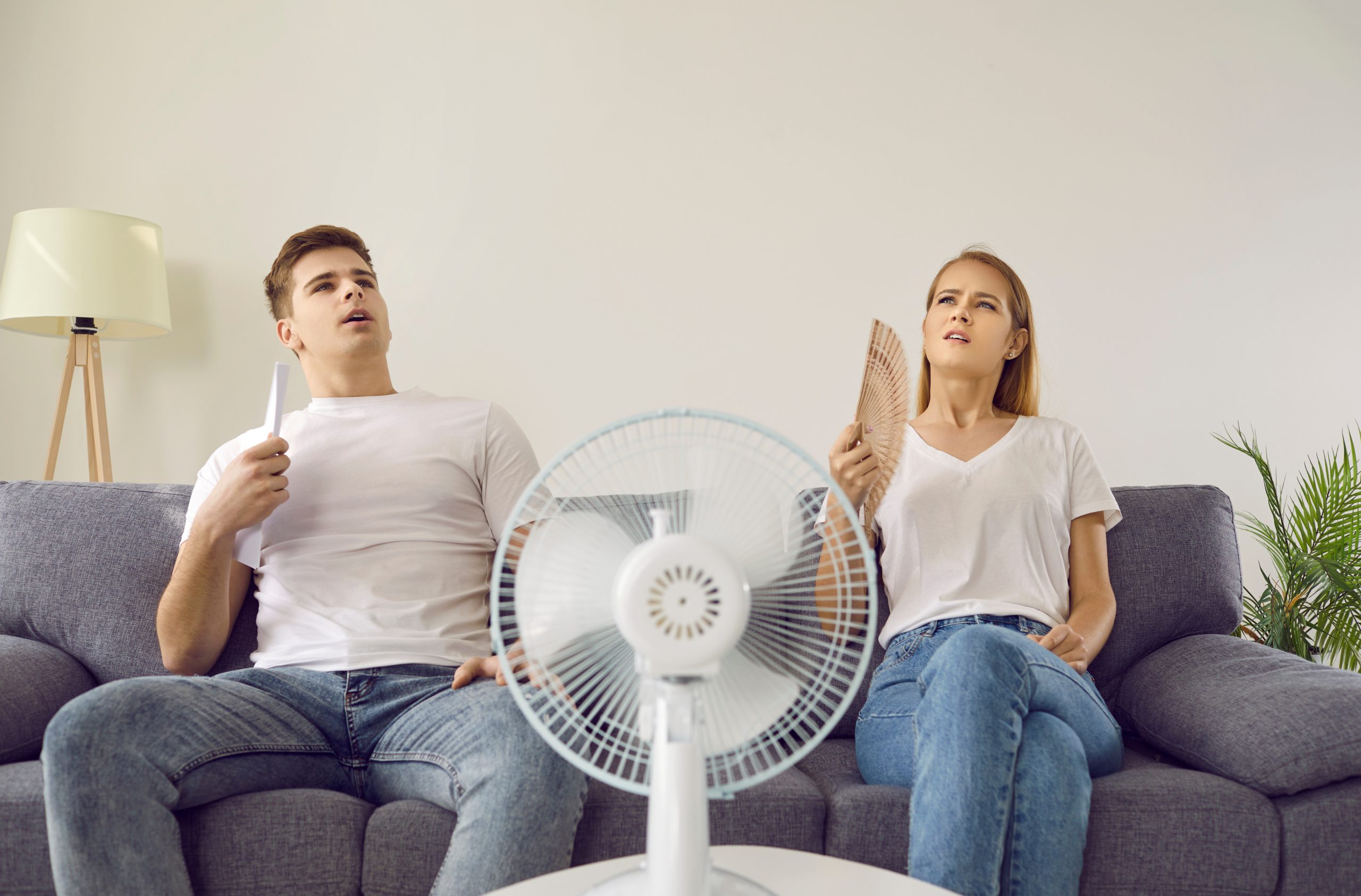 Young couple who are tired from extremely hot summer weather
