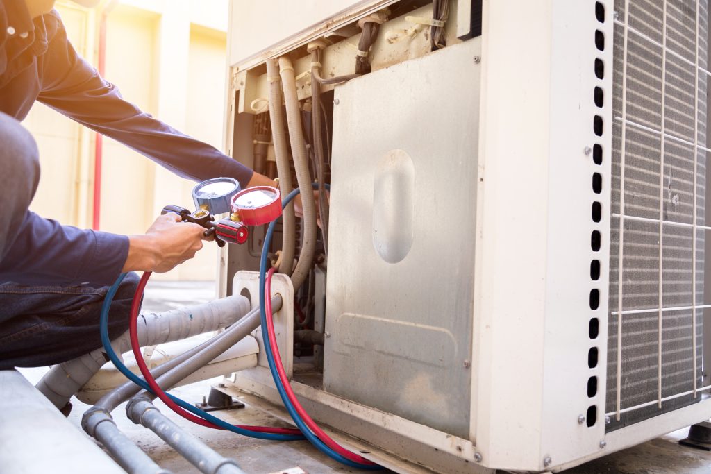 SorensenHVAC, Technician is checking air conditioner